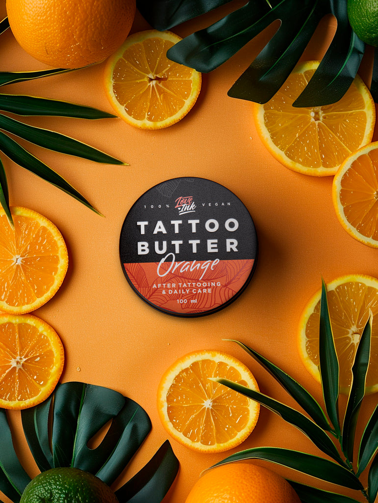 Tattoo Butter Orange 100ml balení v hliníkové plechovce s oranžovou etiketou na pomerančovém pozadí